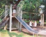 Kendrick Hodges (on the slide) and Nevin Ergul and Paige Edwards play on the equipment given in memory of Frosty Felton.
